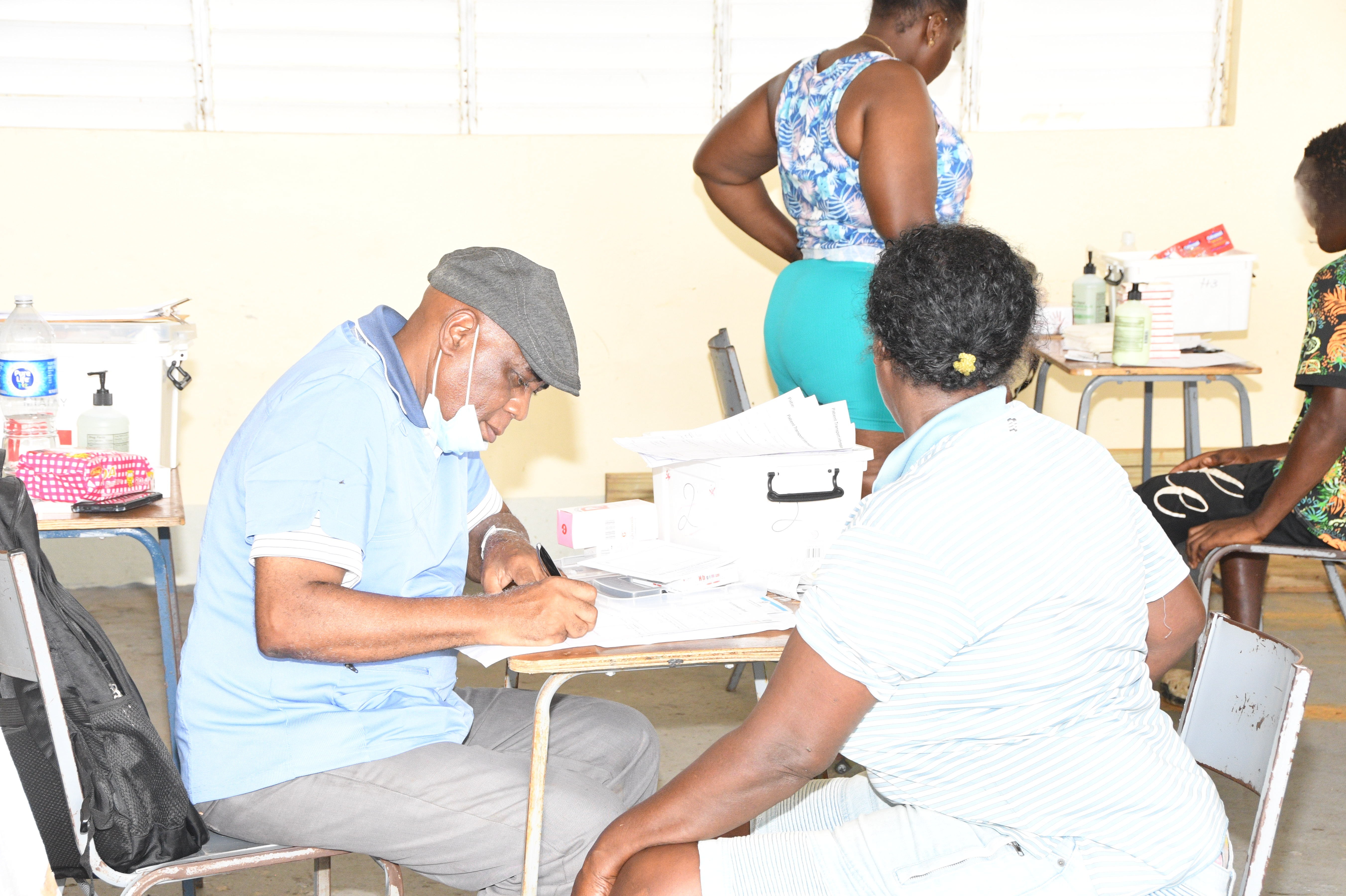 Dr Lazarus Davids of St John Ambulance Jamaica prescribes medication for a Bluefields resident