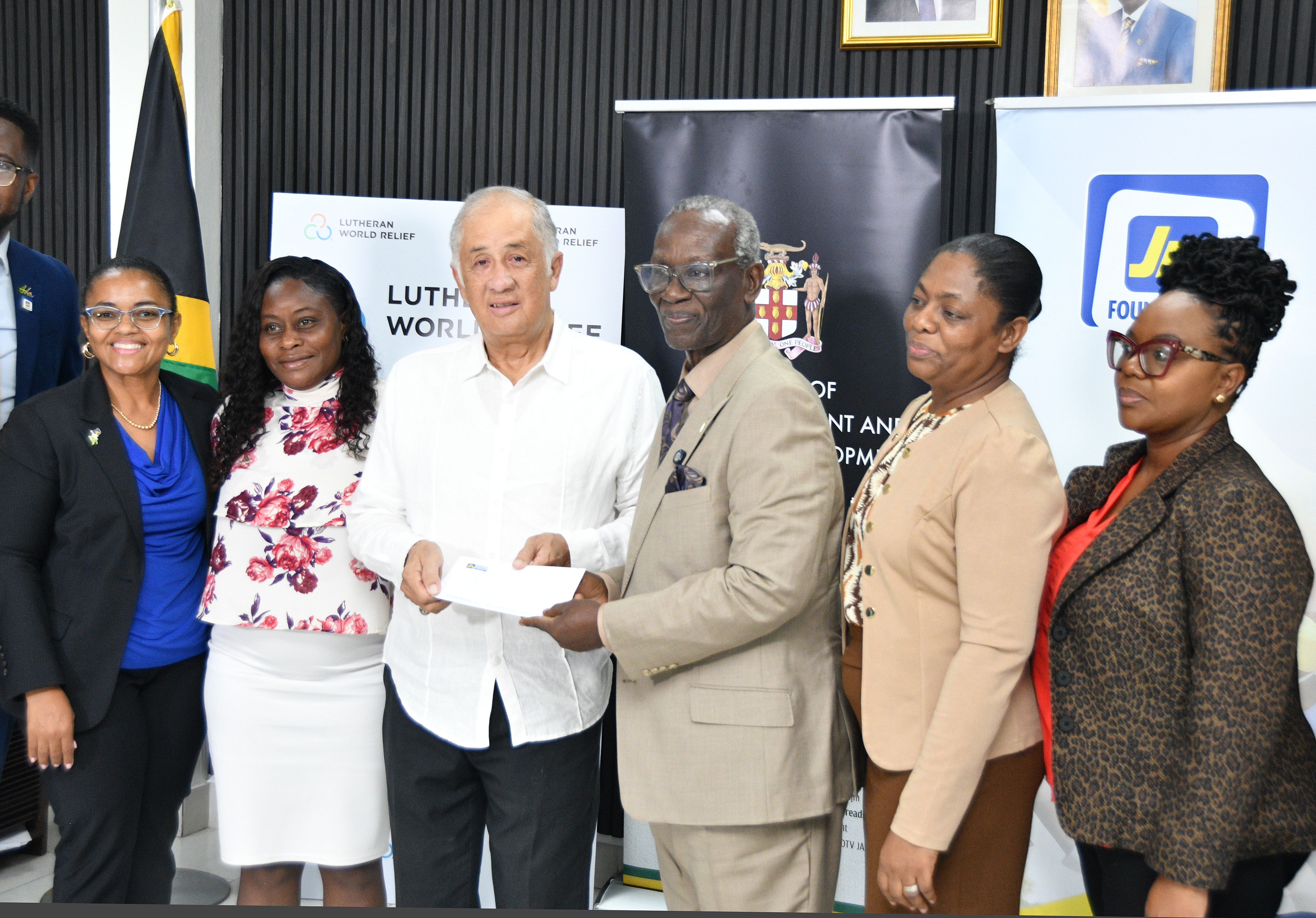 Parris Lyew-Ayee (third left), Chairman of the JN Foundation presents a cheque for the Trelawny Infirmary to Desmond McKenzie (fourth left), Minister of Local Government and Community Development, during a handover ceremony at the Ministry of Local Government and Community Development on Hagley Park Road in Kingston recently. Sharing in the occasion are (from left) , Claudine Allen General Manager of the JN Foundation; Tracey-Ann Bell, Matron of the Trelawny Infirmary; Anniesha Gordon-McFarlane, Principal Financial Officer at the Ministry and Desrene Williams-Taylor, Director of Agency Liaison and Monitoring at the Ministry.