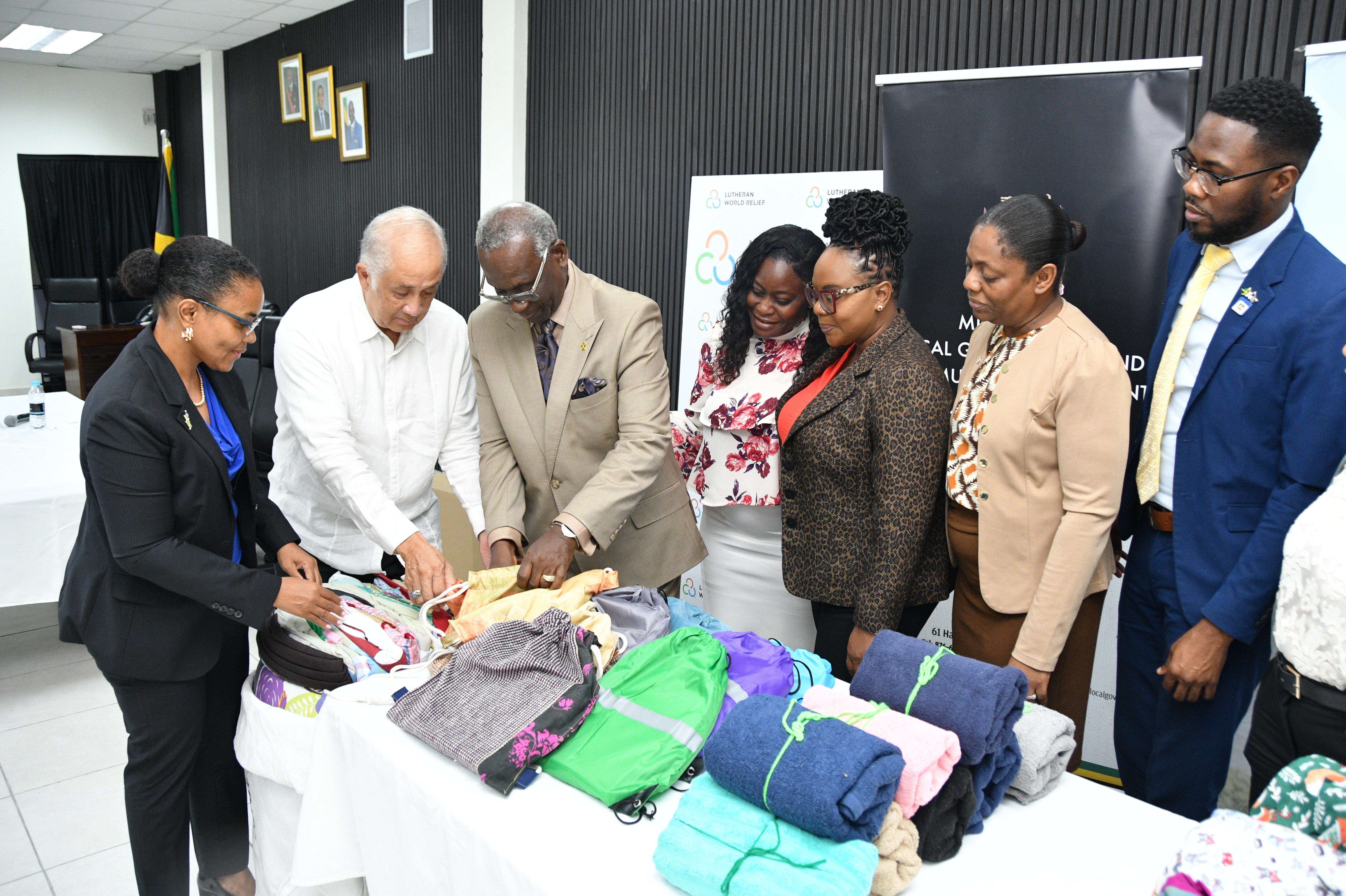 Claudine Allen (left), General Manager of the JN Foundation, and Parris Lyew-Ayee (second left), Chairman of the JN Foundation, show display donated items to Desmond McKenzie (third left), Minister of Local Government and Community Development, during a handover ceremony at the Ministry of Local Government and Community Development on Hagley Park Road in Kingston recently. Sharing in the occasion are (from fourth left) Tracey-Ann Bell, Matron of the Trelawny Infirmary; Desrene Williams-Taylor, Director of Agency Liaison and Monitoring at the Ministry; Anniesha Gordon-McFarlane, Principal Financial Officer at the Ministry; and Omar Wright, Lead, Environment and Community Development Programmes at the JN Foundation. More than 13,700 essential relief items and JMD $1.25 million raised through the iSupportJamaica Fund were handed over to the ministry and to help to restore the Trelawny Infirmary which was severely damaged during the storm.